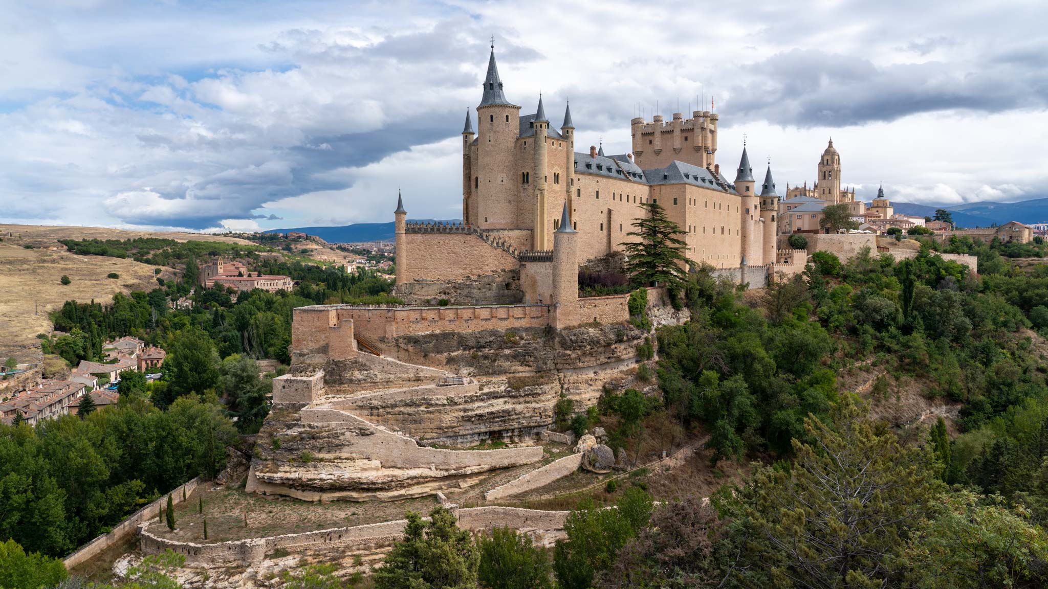 The Alcazar of Segovia on a cloudy day perches on a hill is a Spanish hidden gem